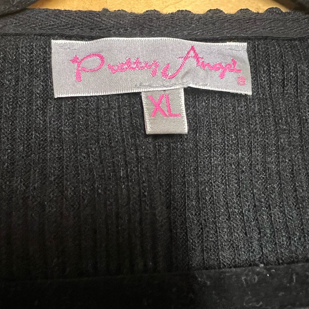 Black knit long shirt adorned with lace. Worn once. Got lots of compliments.